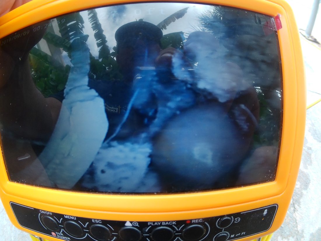 Pipe camera monitor showing a separated gutter feeder pipe on a commercial pool